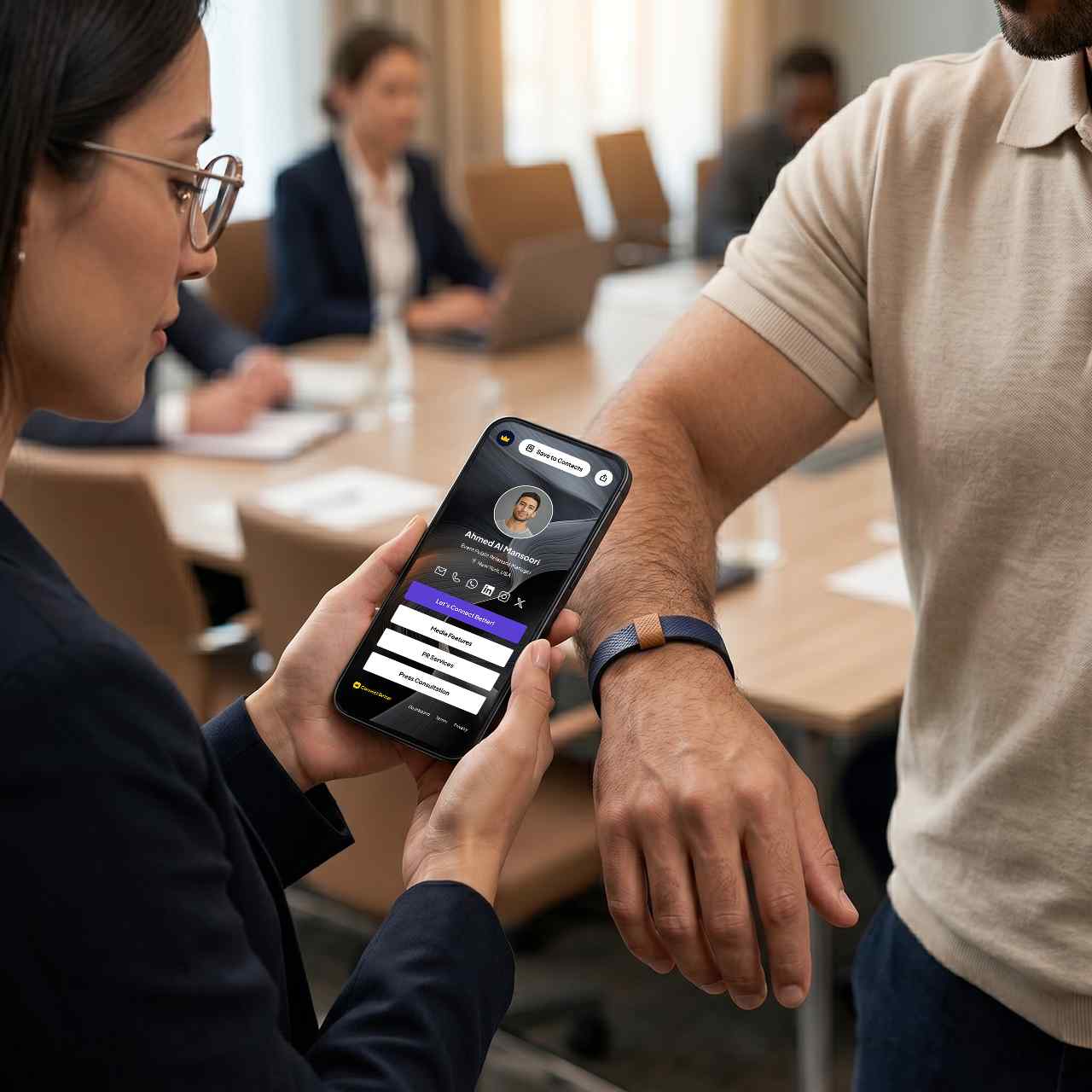 A professional taps a Signature Cuff against a phone to open a profile