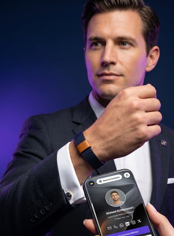 An executive shows the Signature Cuff on his wrist while his Connect Better profile opens on a phone